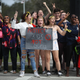 Some of the hundreds of West Boca High School students arrive at Marjory Stoneman Douglas High School in Parkland, Fla., after they walked there in honor of the 17 students shot dead last week on Feb. 20, 2018. {Joe Raedle/Getty Images)